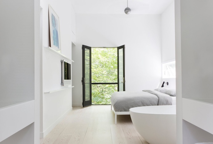 master bedroom with whitewashed douglas-fir floor and a balcony