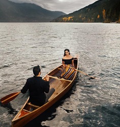 A romantic pre-wedding pose under a boat, capturing the love and intimacy between couples, perfect for creative couple poses in pre-wedding shoots.