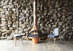 The lobby of the Coast Kitchen, the hotel's 54-seat restaurant, has a copper gas stove and a full-height natural stone wall.