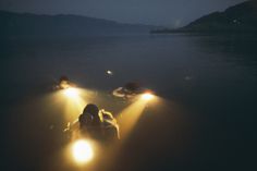 Many methods were tried, some unorthodox, in an effort to lure the Loch Ness monster into camera range. Here brave divers execute a baiting #water #ness #divers #dive #night #photography #deep #vintage #lake #loch