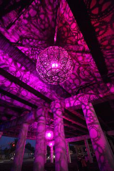 Recycled Bike Part Chandeliers Under a Texas Overpass #chandelier #color #light #purple