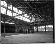 Ford Long Beach Assembly Plant TIME CLOCK AREA, WITH LUNCH ROOM IN DISTANCE. RAIL SPUR FOLDING DOORS ARE HIDDEN BEHIND OFFICE AT PHOTO CENTE #factories #structure #roofs #architecture #sawtooth