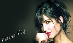 A stunning photo of Katrina Kaif from her Vogue photoshoot, showcasing her beauty with long hair and bold red lipstick.
