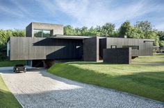Black Modern House Consisting of Five Modules Clustered Around a Central Courtyard 2