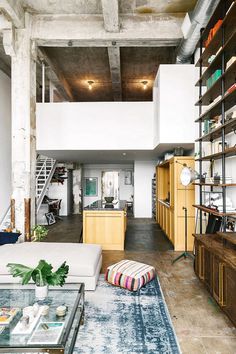 Discover this stunning Brooklyn loft featuring aged brick, concrete floors, and exposed beams, perfect for those who love industrial-chic interior design.