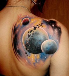 A stunning tattoo design featuring planets on a woman's back, paired with a delicate necklace, showcasing celestial inspiration in body art.