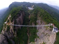 High-altitude suspension bridge made of glass opens in Hunan, China