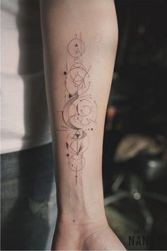 Fine line geometric tattoo on the left inner forearm.