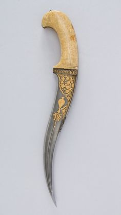 Dagger (Pesh-kabz) Date: 17th century Culture: North Indian Medium: Steel, gold, ivory (walrus) Dimensions: H. 15Â 1/8 in. (38.4Â cm); H. of #history #weapon #curve #historical #blade #photography #archaeology #knife #beauty