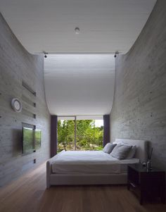 Curving roofline enhances acoustics inside house by NKS Architects