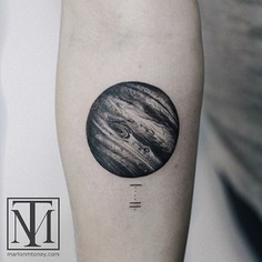 A stunning black and grey tattoo design featuring Jupiter, the planet, on someone's arm with the number one subtly placed underneath, showcasing unique ink artistry.