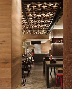 A modern Japanese restaurant design featuring a striking black, red, and warm timber color palette, perfect blend of traditional Japanese aesthetics with modern elements.