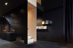 a floating staircase defines interior of bazar noir by hidden fortress #float