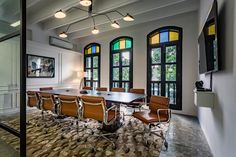 A sleek office space with several chairs around a table, offering stunning views through large windows.