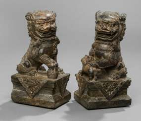Pair of Buddhist lions, and a black-and-brown stone
