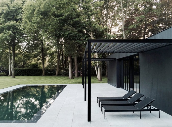 Pool patio with black steel pergola. CD Poolhouse by Marc Merckx. #pergola #pool #patio