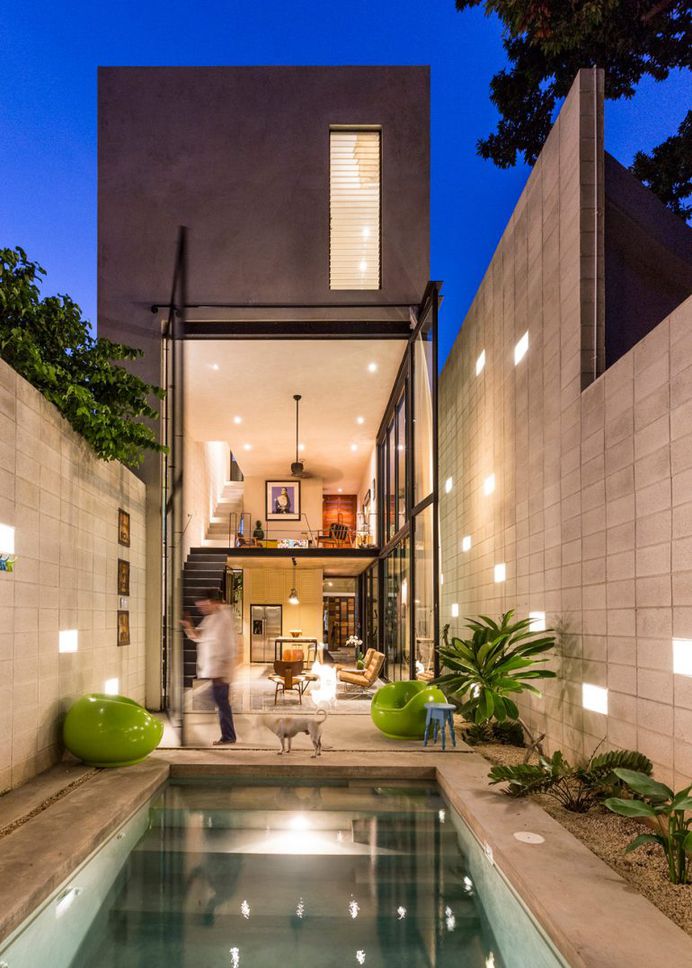 Huge glass doors open Mexican house to a courtyard garden