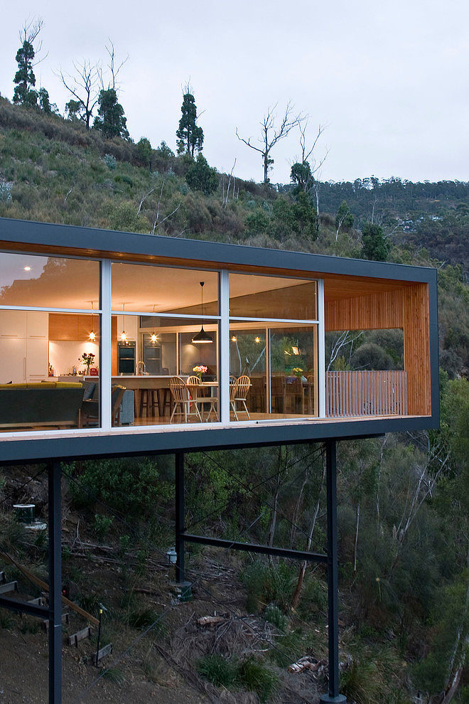 Wood house with single level "built at the height" on a metal frame