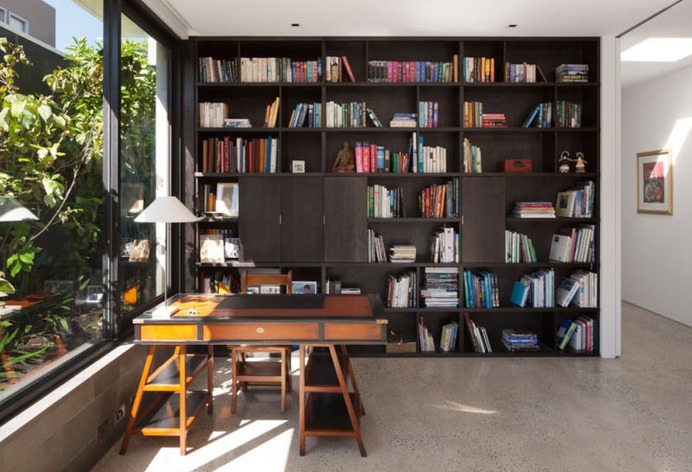remodelproj: "Home office with full height bookcase surrounded by exterior greenery "
