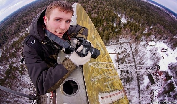 Man on top of a rusty satellite dish #photography