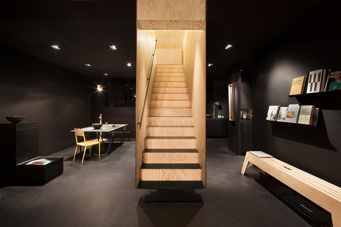 a floating staircase defines interior of bazar noir by hidden fortress #float