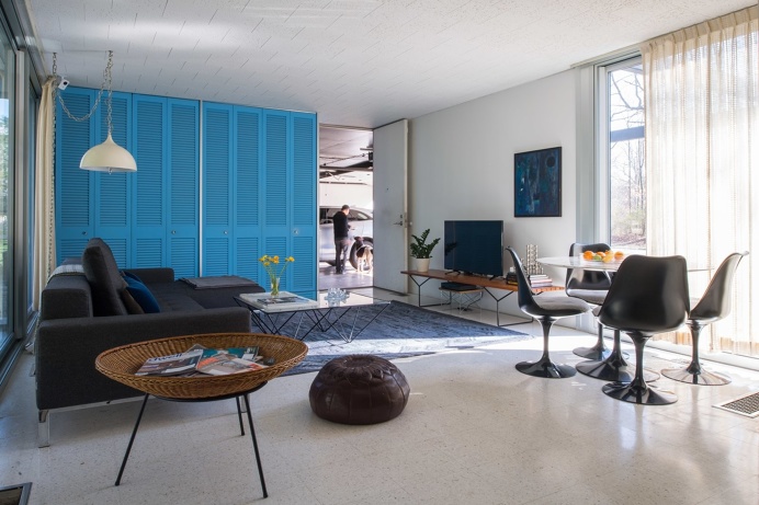 A Bertoia Bench in white oak supports the TV in the family room, while a 50th anniversary-edition Saarinen Tulip Table and Chairs provide a