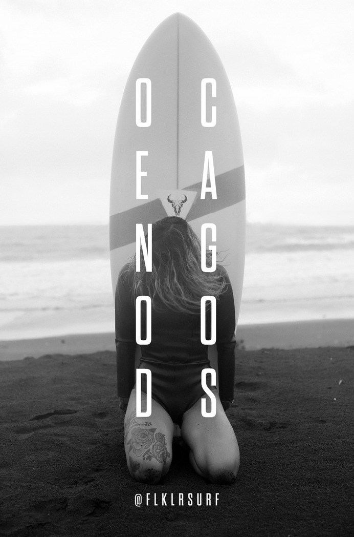 Surfer with twin fin surfboard behind her on a tropical beach