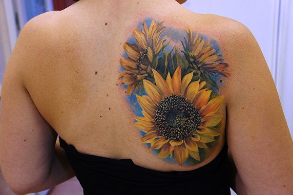 Sunflower tattoo on the back of the right arm