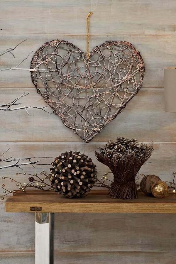 A wood inspired heart shaped craft using twigs to shape the symbol. Wires and ropes are used to hold the shape as well as the intricate and