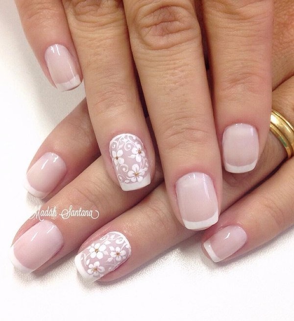Nude nail art with floral details and French tips. Combing your French tips with floral details to make the nude nail polish from beneath st