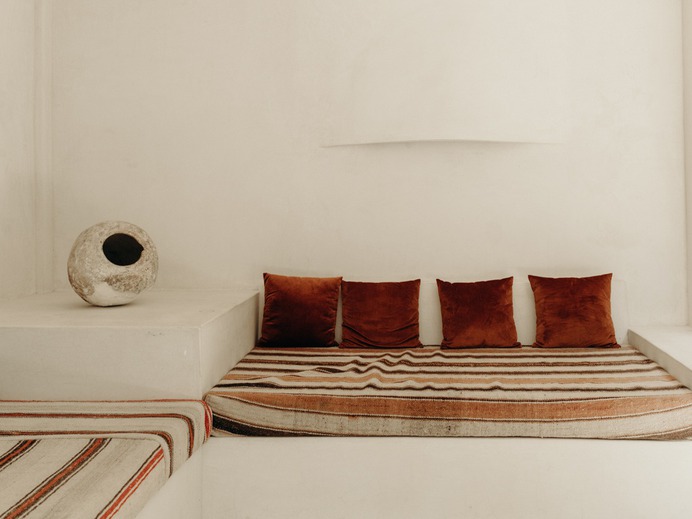 Built-in day beds in the lounge area. Both the hotel's pueblo-inspired architecture and minimalist interior design are by Klein and Mike Moser. Note the seamless hand-sculpted sconce by artist Justin James.