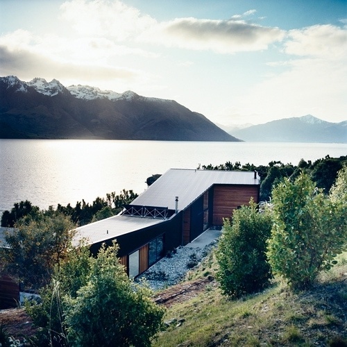 A remote house next to a lake and mountains | Murray Mitchell #roofs #butterfly #wood #architecture #landscapes #houses
