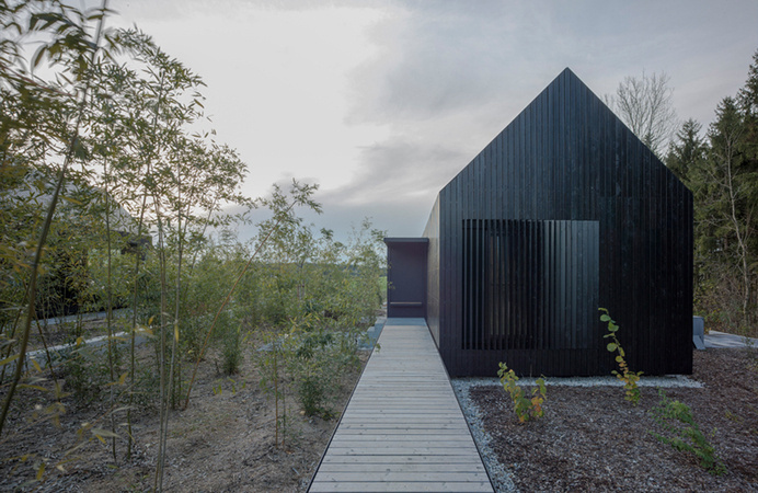 format elf nestles dark barn-shaped houses into bavarian forest #home