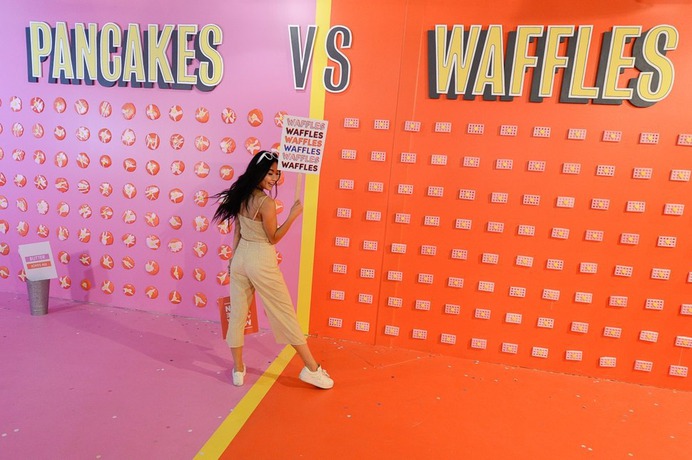 (Francisco Kjolseth | The Salt Lake Tribune) Jiajing Yi poses for a friends camera during a visit to Hall of Breakfast, a quirky new art exhibit that celebrates the first meal of the day. In the waffle and pancake room, visitors can vote for their favorite breakfast carbohydrate.