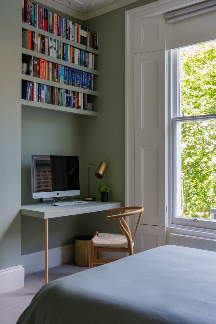 While the public living spaces are modern and sleek, the bedrooms, which are all housed in the existing structure, are more traditional, with Victorian high ceilings, decorative cornicing, and shutters. The second-floor guest bedroom (which turns into a den for Olivia and her boyfriend when the sleeper sofa is folded up) is painted Farrow & Ball's Blue Gray.