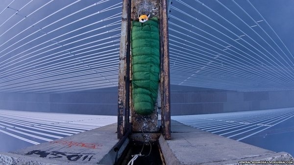 Explorer in a sleeping bag on top of a bridge. #photography