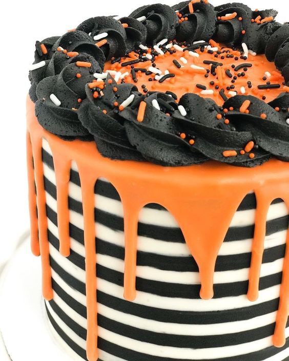 Wilton Cake Decorating on Instagram: "@elsiemakescakes made this Halloween festive black and white cake using our orange Candy Melts for the drip! 🖤🧡What are you baking for…"