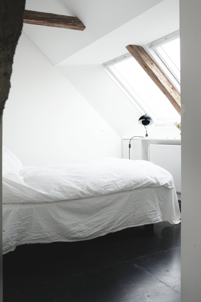 Loft bedroom with rustic wood beams and roof windows. Humlebaek House by Norm.Architects. #normarchitects #loft #bedroom #rusticbeam