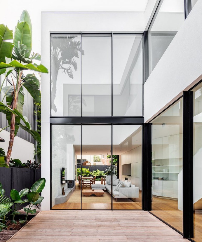 The internal courtyard looks into the living, dining and kitchen space of the home's groun ...