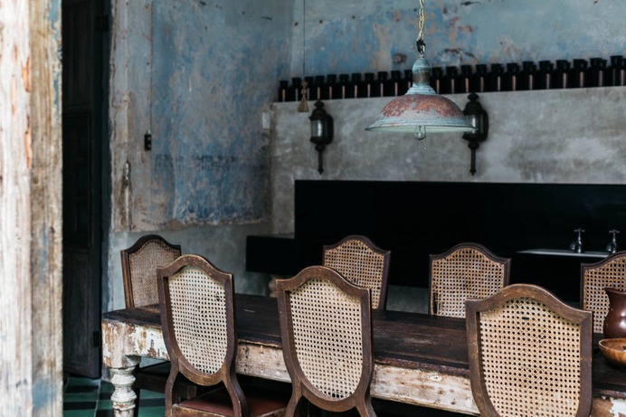 The walls reveal the building's history, with peeling paint and frescoes.