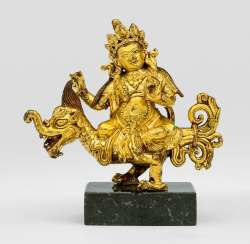 Fire gilt Bronze of a deity, perhaps Jambhala on dragon riding
