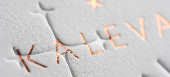 Letterpress business cards with copper foil and blind deboss combination.