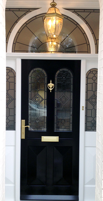 Victorian door with two leaded glass panels, sidelights, fanlight and a lamp. #sidelights #fanlight #door #victorian #panelled