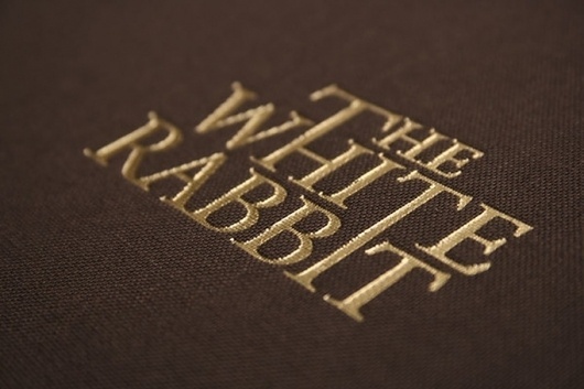 The White Rabbit #embossed #wordmark #texture #typeography #gold #rabbit #foil