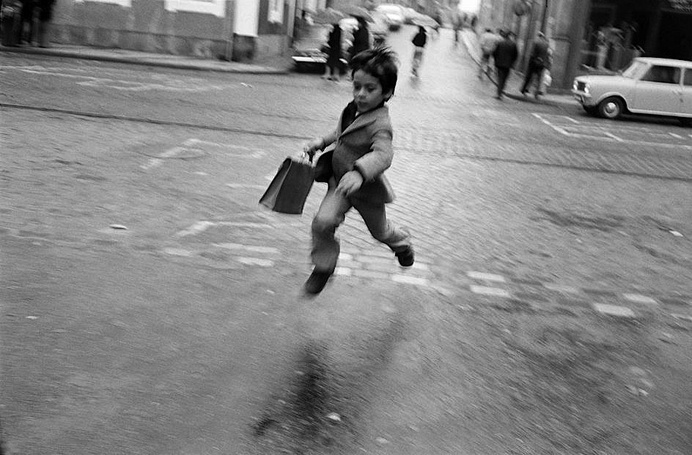 Josef Koudelka. 'Lisbon, Portugal' 1975 #white #prance #boy #skip #blur #child #infant #black #road #street #photography #jump #and #work