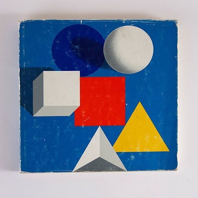 Bauhaus book designed by Herbert Bayer via Javier Garcia featuring minimal geometric shapes and a primary color palette