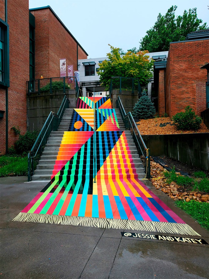 Artist Duo Brings Life Into A Boring Old Stairway By Painting A Bright And Colorful Rug-Shaped Mural