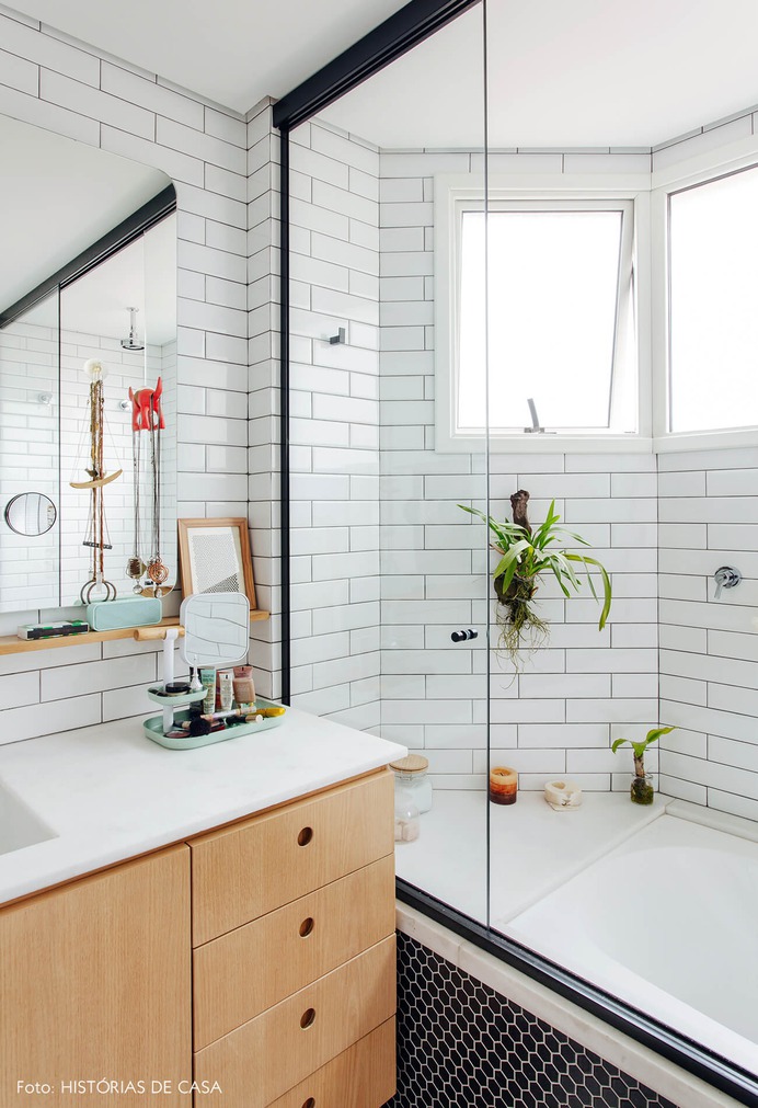 Banheiro reformado com azulejos do tipo subway tiles e marcenaria neutra