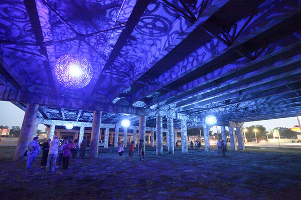 Recycled Bike Part Chandeliers Under a Texas Overpass #light #color #purple #chandelier