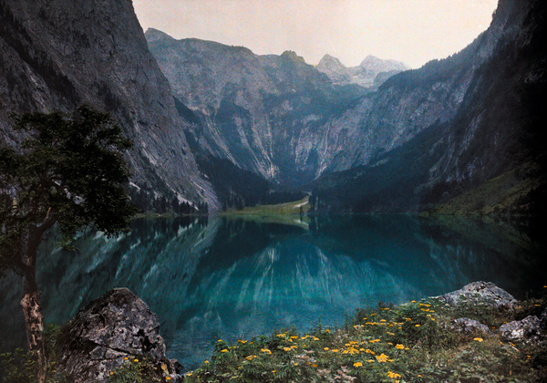 This glacial lake sits between mountains and a wild crag in Bavaria, Germany, December 1928.Photograph by Hans Hildenbrand, National Geograp #germany #nat #nature #photography #vintage #film #lake #mountains